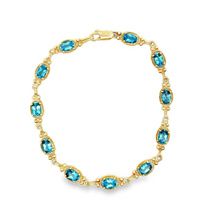 14Y Oval Blue Topaz Bracelet with Beaded Frame Details 7.5"